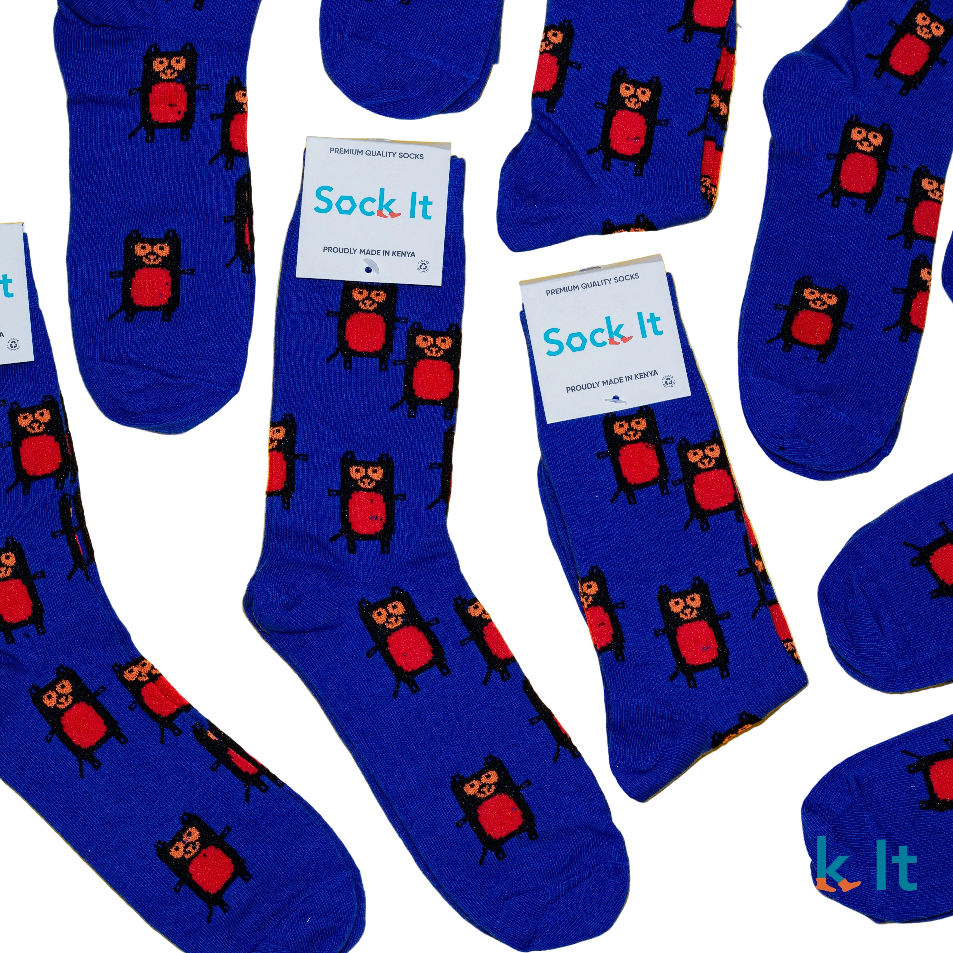 Blue socks with owl pattern and 'Sock It' packaging on a yellow background