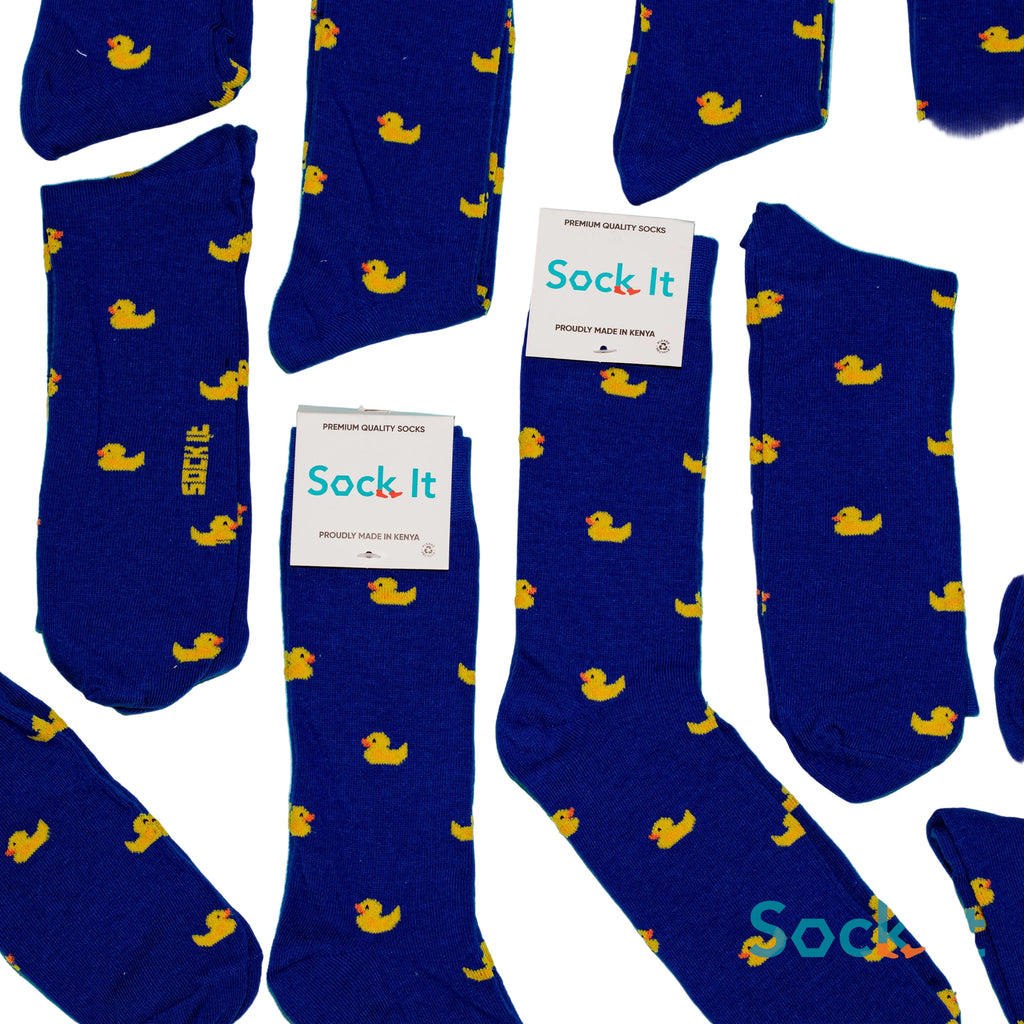 Blue socks with yellow duck patterns and 'Sock It' labels on a blue background
